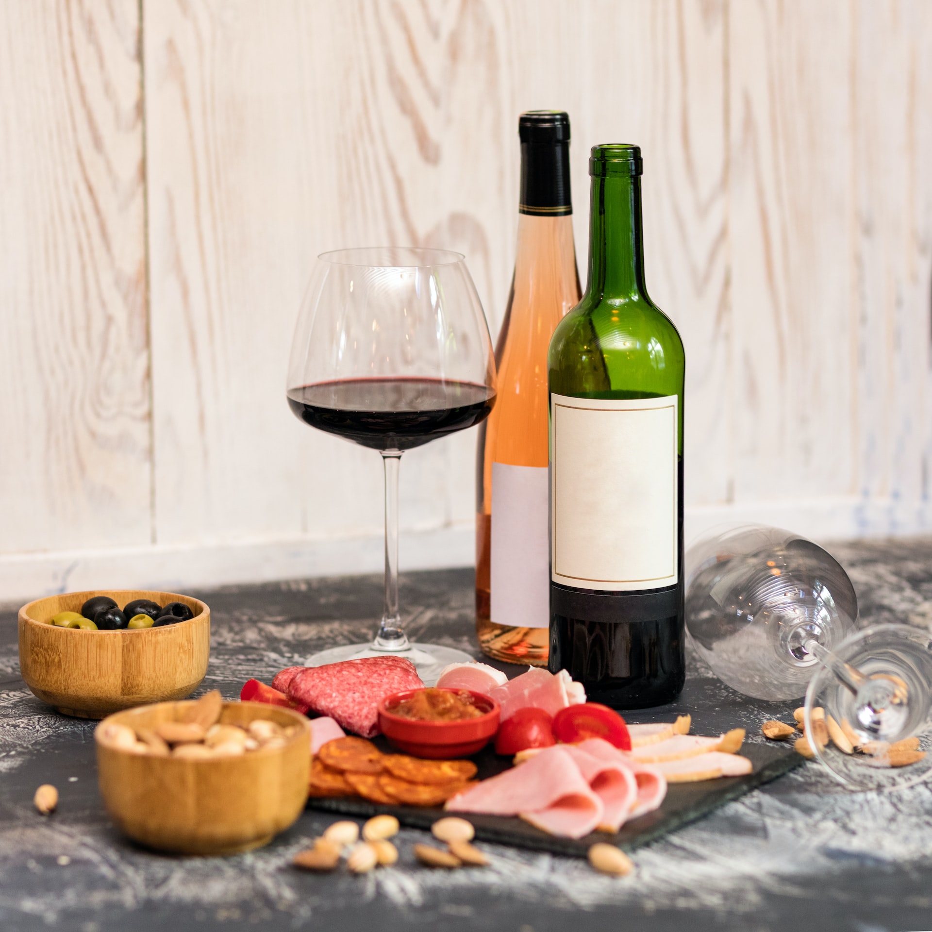 wine bottle beside wine glass on table
