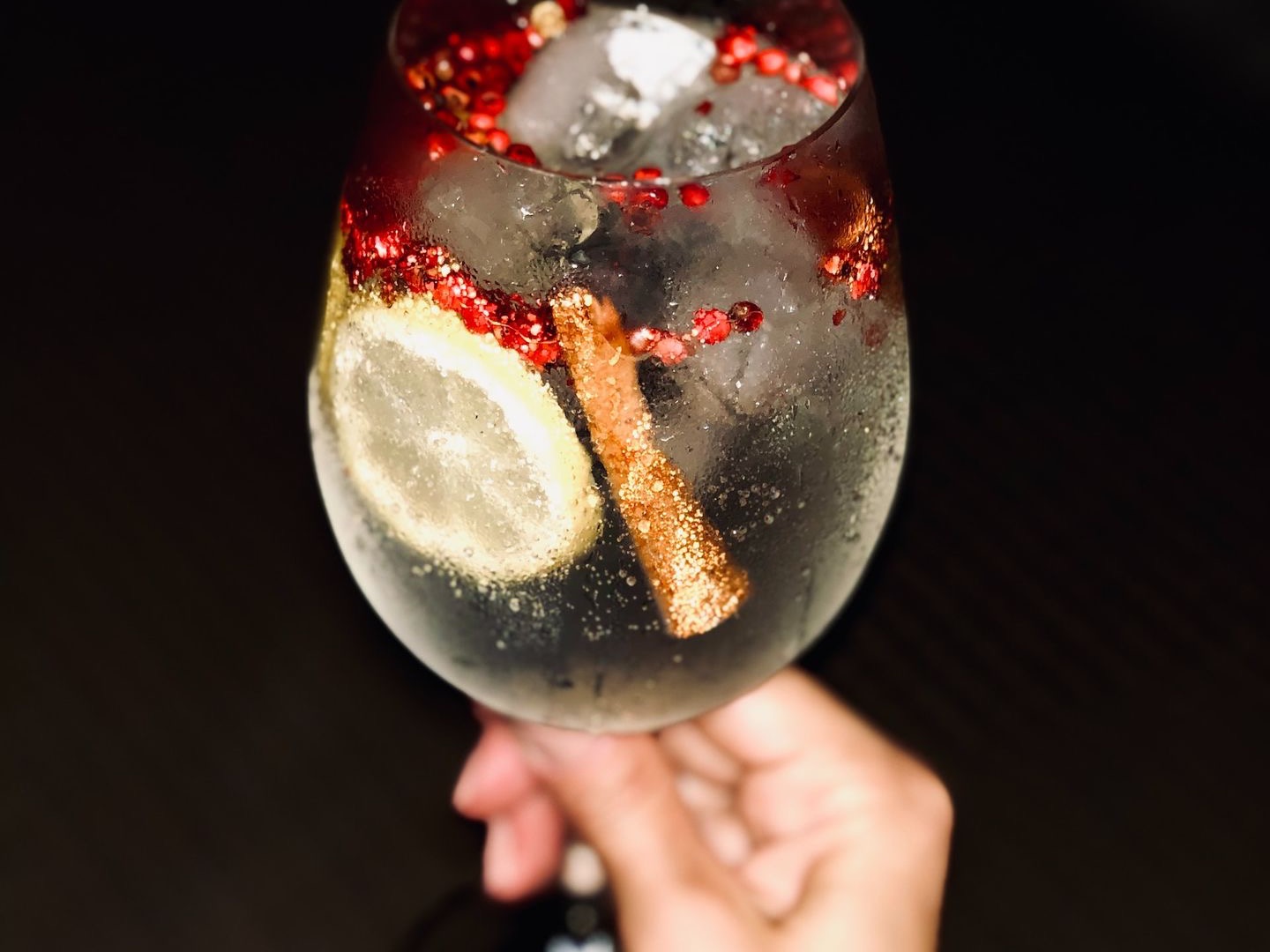 person holding red and black round ornament