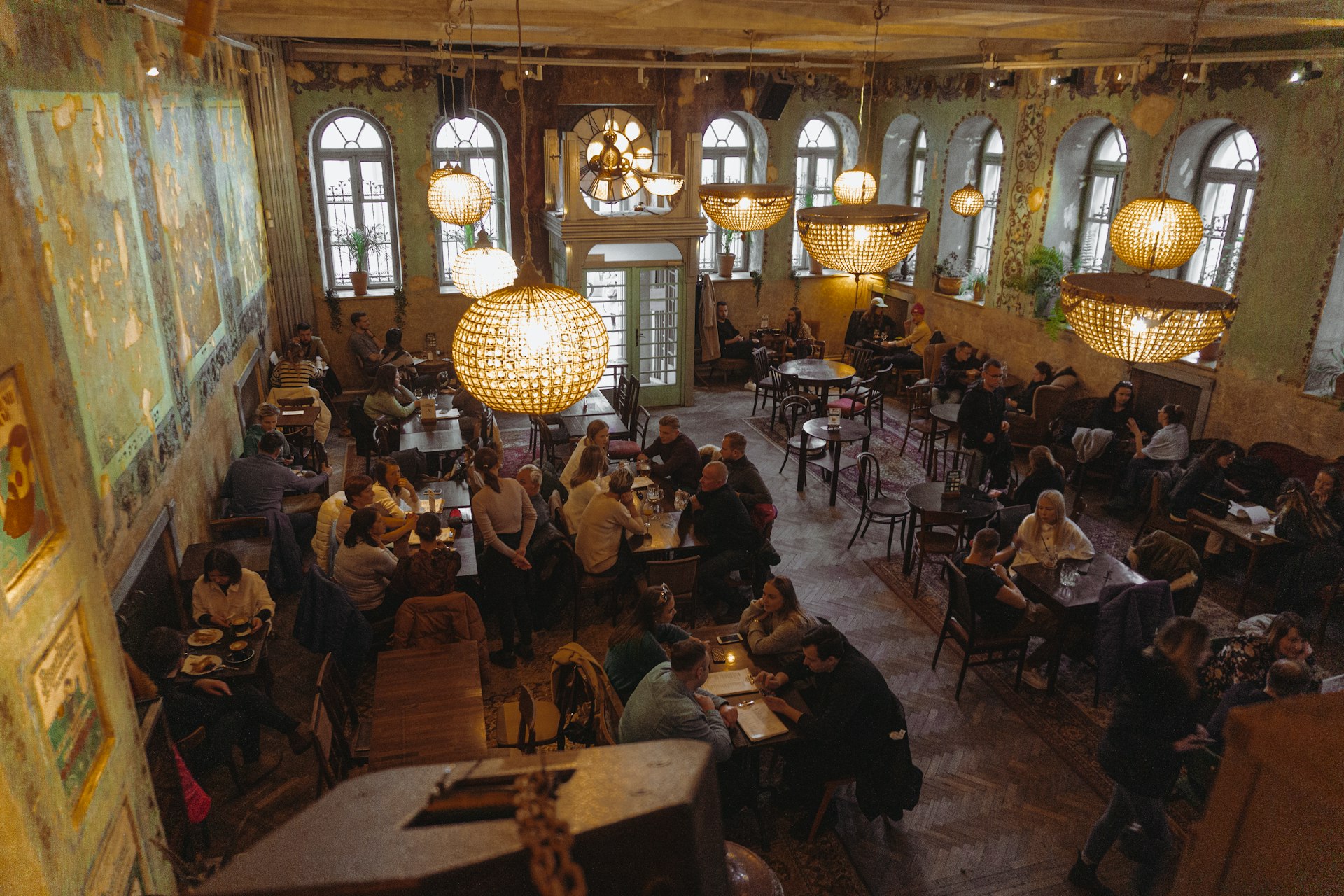 a restaurant filled with lots of people sitting at tables