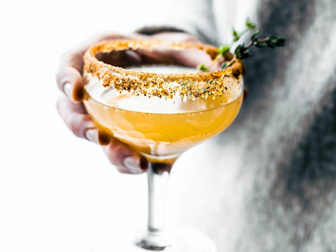 tilt shift lens photography of person holding wine glass