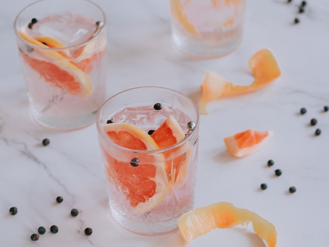 a couple of glasses filled with drinks on top of a table