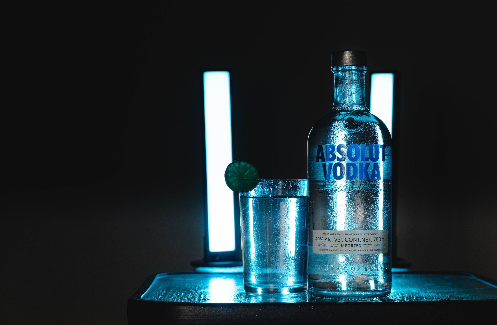 a bottle of vodka next to a shot glass